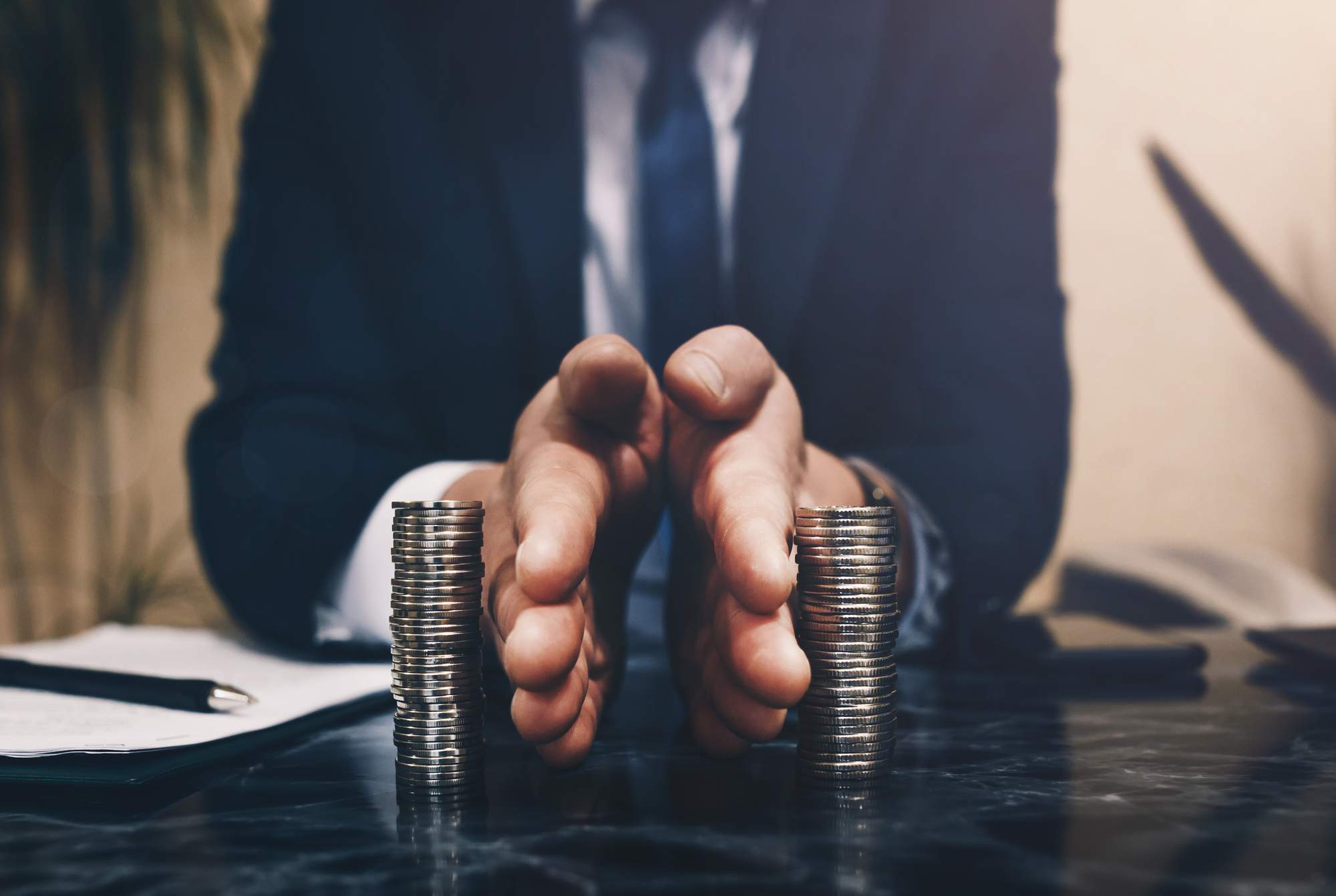 businessman-separates-stack-coins-concept-saving-investing