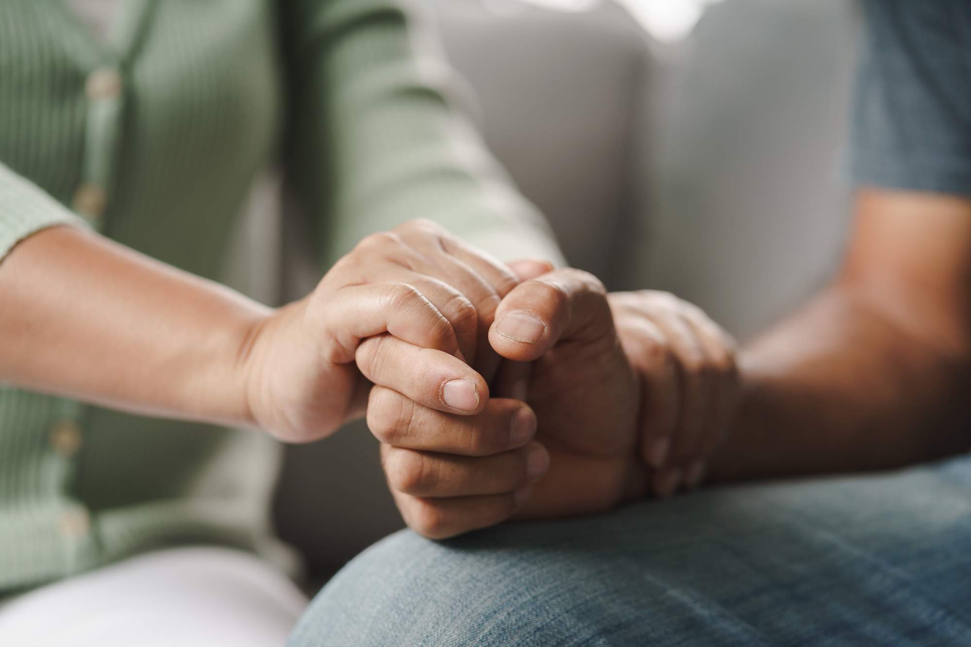 female-friend-family-sitting-hold-hands-during-cheer-up-mental-depress-man-psychologist-provides-mental-aid-patient-ptsd-mental-health-concept