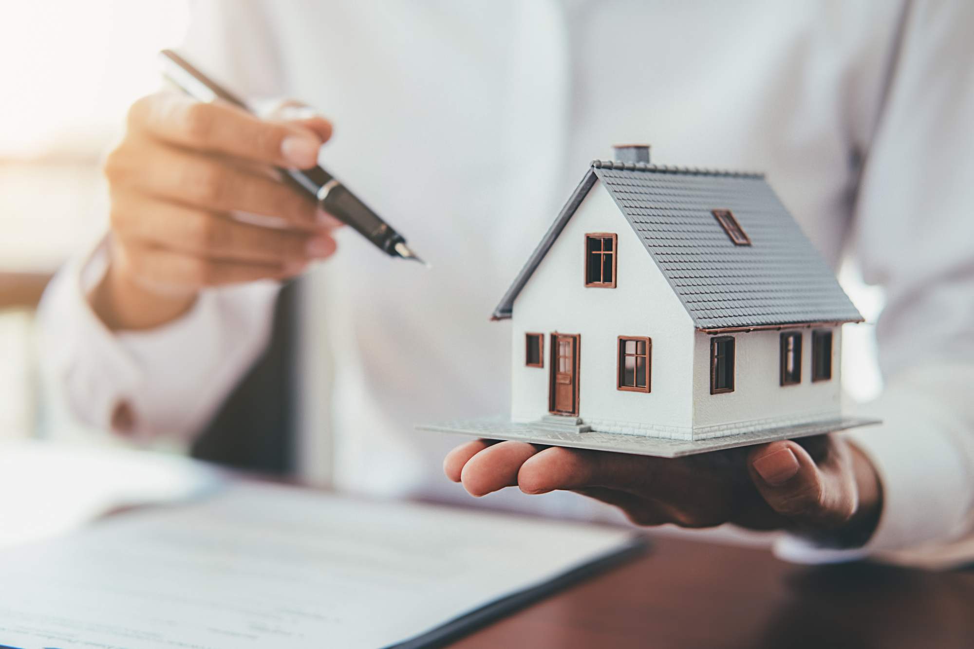 house-model-with-real-estate-agent-customer-discussing-contract-buy-house