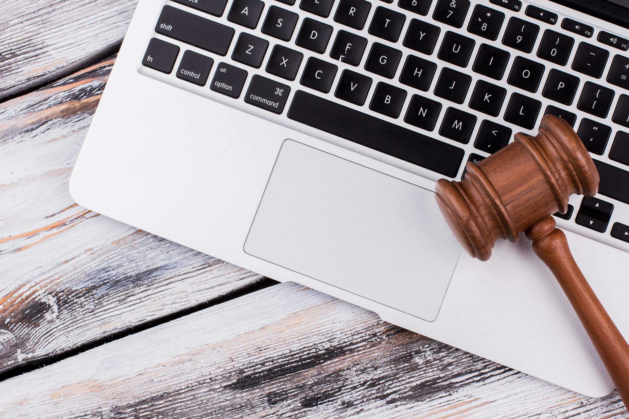 wooden-court-gavel-laptop-keyboard-old-white-wooden-table